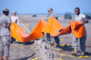 Setting up water dams to protect shoreline.